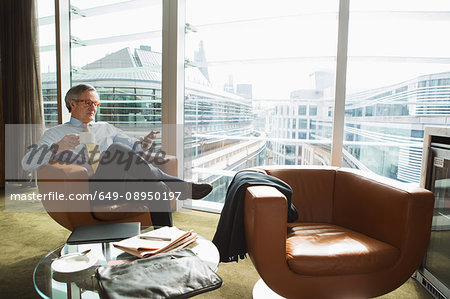 Businessman in coffee area in office, London, UK