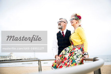 1950's vintage style couple at beach looking up