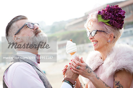 1950's vintage style couple with ice cream cone at beach