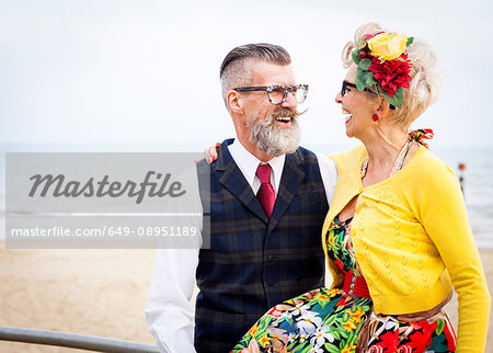 1950's vintage style couple laughing at beach