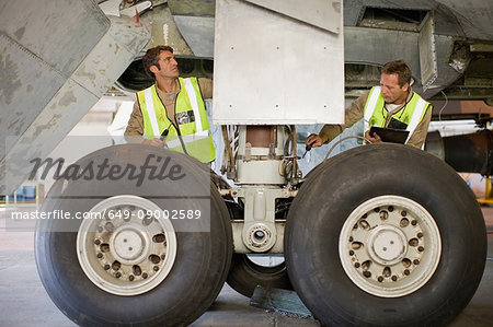 Aircraft workers checking airplane