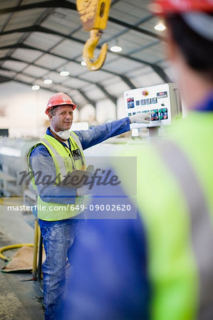 Worker in mask using machinery