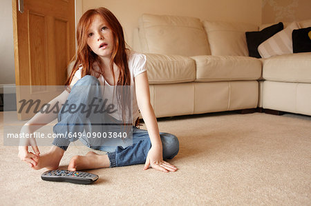 Girl watching television in living room