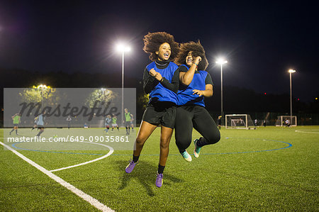 Female football players jubilant, Hackney, East London, UK