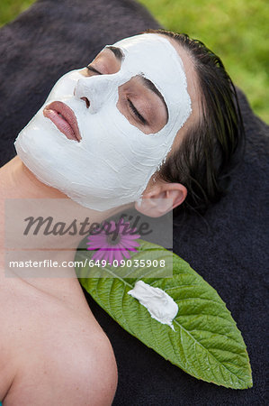 Woman in spa environment, wearing face mask