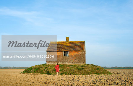 Woman and deserted house in a polder, rear view, Dordrecht, South Holland, Netherlands, Europe
