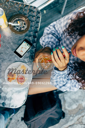 Woman at pavement cafe, Milan, Italy