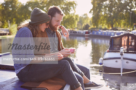 Couple eating cupcakes on canal boat