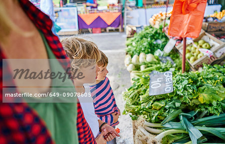 Mother and sons shopping at fruit and veg stall at market, Montevideo, Uruguay, South America Mother and sons shopping at fruit and veg stall at market, Montevideo, Uruguay, South America
