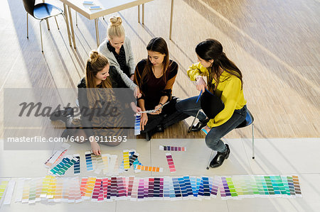 Colleagues sitting on floor working with colour swatches
