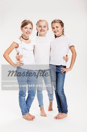 Studio portrait of three girls posing with hands on hips - Stock Photo -  Masterfile - Premium Royalty-Free, Code: 649-09111671