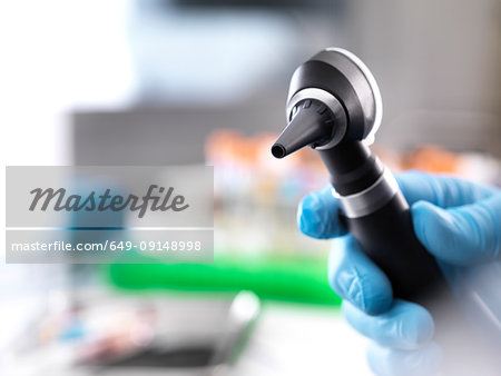 Cropped view of doctor holding otoscope