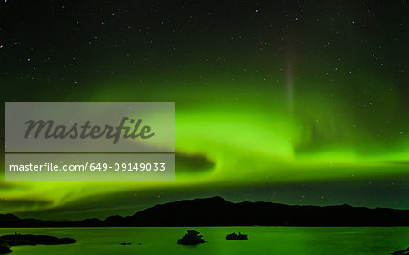 Aurora Borealis above mountain range, Narsaq, Vestgronland, Greenland