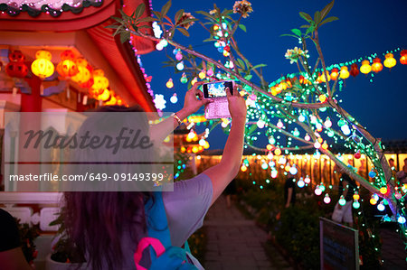 Tourist taking photograph of light decorations, Kek Lok Si Temple, Penang Island, Malaysia