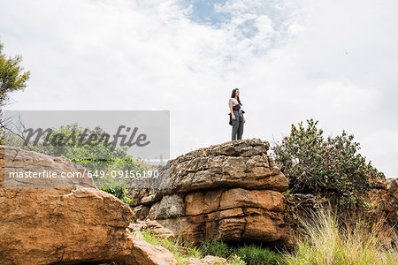 Young female tourist looking out from rock at Bourkes Potholes, Mpumalanga, South Africa