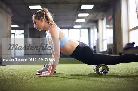 Woman using foam roller in gym
