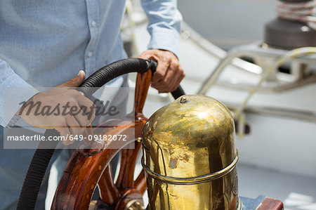 Man steering sailboat