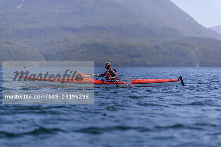 Woman kayaking in lake, Johnstone Strait, Telegraph Cove, Canada