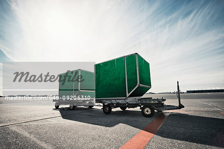 Green boxes on carts in airfield