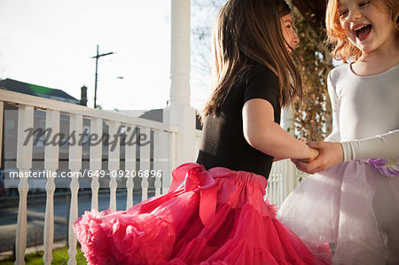 Girls dancing in ballet costumes on porch