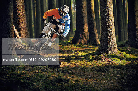 Female on mountain bike riding through forest