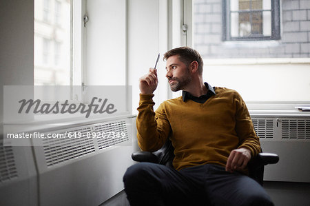 Casual businessman looking out of window