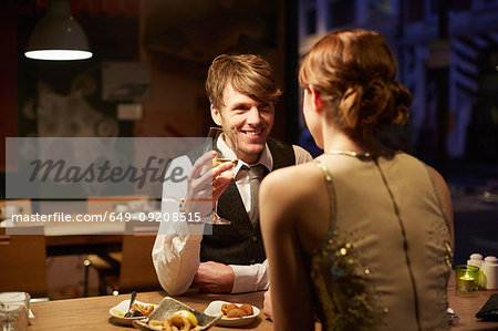 Couple in restaurant, man holding wine glass