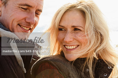 Mature couple, outdoors, smiling, close-up