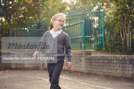 Elementary schoolgirl playing in playground