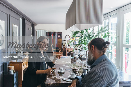Couple in discussion over coffee in kitchen