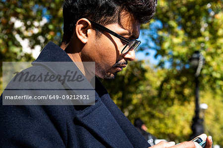 Businessman using smartphone outdoors