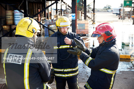 Firemen in discussion in training centre, Darlington, UK