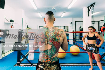 Male and female boxers working out in boxing ring