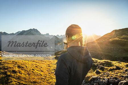 Hiker taking break with warm drink, Karwendel region, Hinterriss, Tirol, Austria