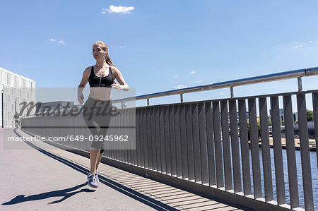 Premium Photo  Young fitness woman running on a stadium. athlete