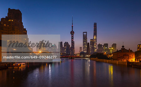 Waibaidu bridge over Huangpu river with Pudong skyline at night, Shanghai, China