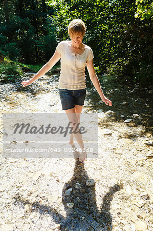 Woman dancing with her shadow on ground, Sonthofen, Bayern, Germany