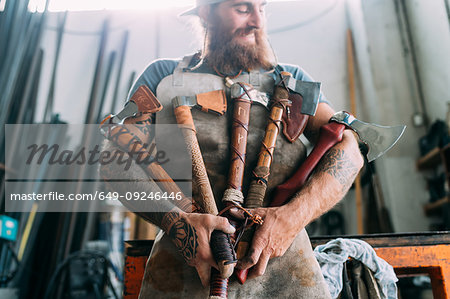 Axe maker showing off variety of handcrafted axes