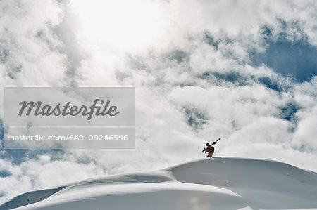 Male skier on top of snow covered mountain, Alpe-d'Huez, Rhone-Alpes, France