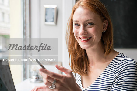 Woman using smartphone in office