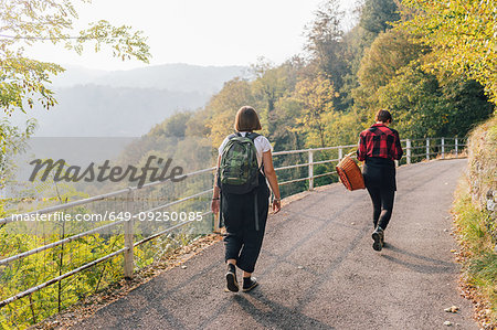 Friends on hillside road, Rezzago, Lombardy, Italy