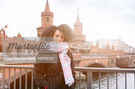 Mid adult woman in scarf on Oberbaum Bridge, portrait, Berlin, Germany
