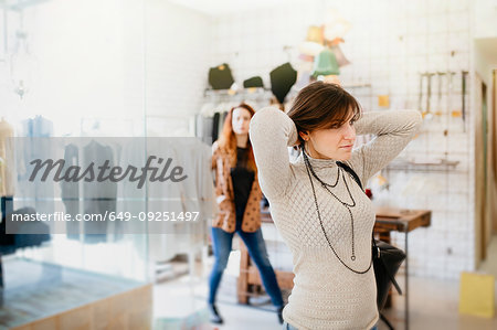 Girlfriends shopping in fashion boutique