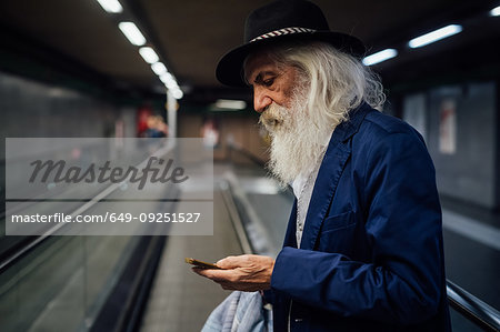 Senior businessman using smartphone inside terminal