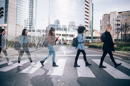 Friends crossing road on zebra crossing Friends crossing road on zebra crossing