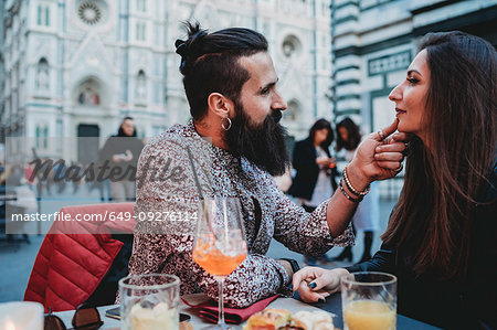 Man tenderly touching chin of woman in cafe, Santa Maria del Fiore, Firenze, Toscana, Italy