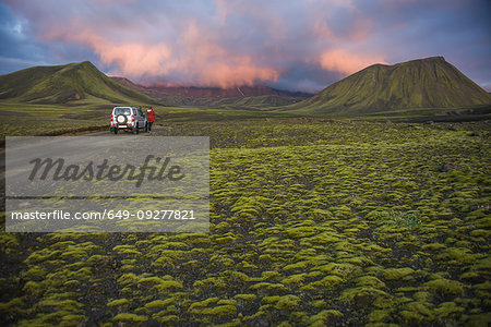 Hiker exploring mossy landscape, Landmannalaugar, Highlands, Iceland