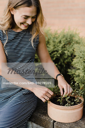 Woman gardener tending to seedlings