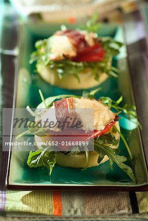 Goat cheese,duck breast,red peppers and rocket on polenta galette