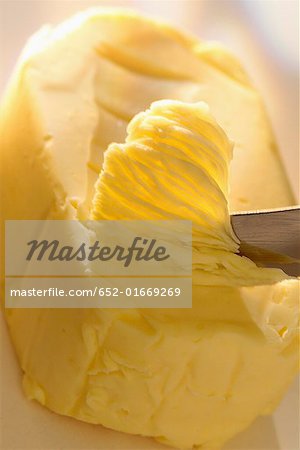 knife scraping pat of butter